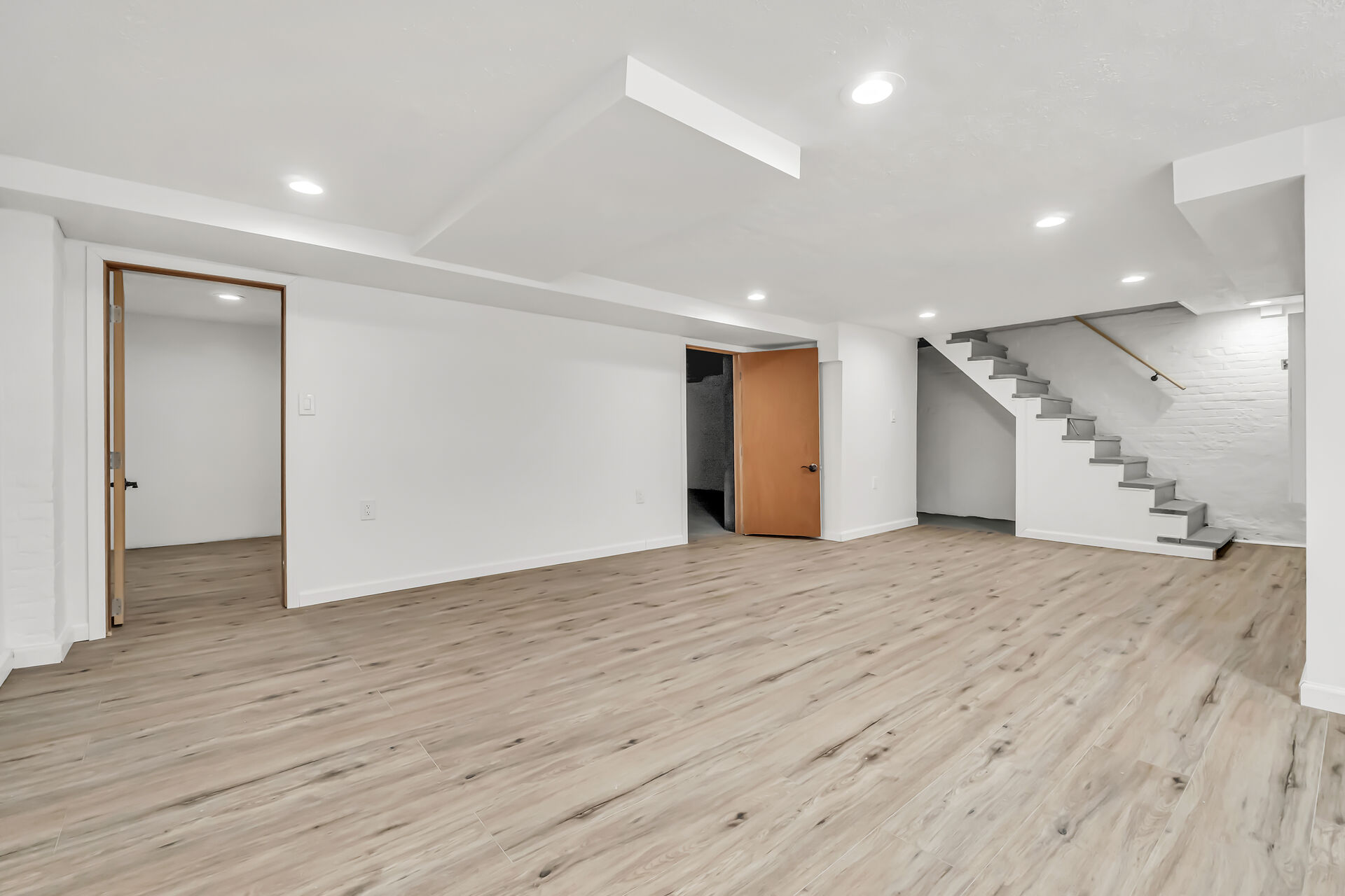 Basement with door to addtional room:closet (left) and to heater:pipes area on right
